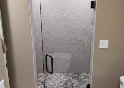 Glass shower door installed by Downey Construction