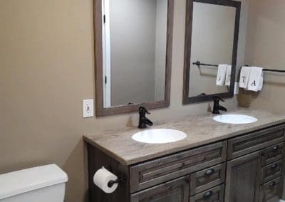 Two bathroom sinks and mirrors installed by Downey Construction