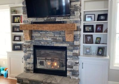 Stone brick fireplace installed by Downey Construction