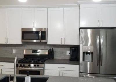 White kitchen cabinets installed by Downey Construction