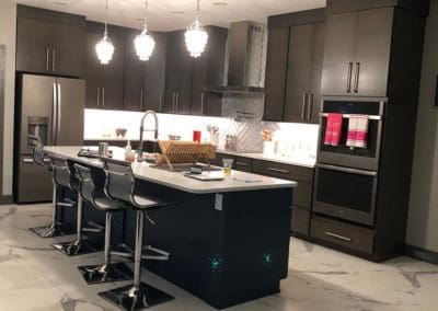 Dark kitchen cabinets and island by Downey Construction